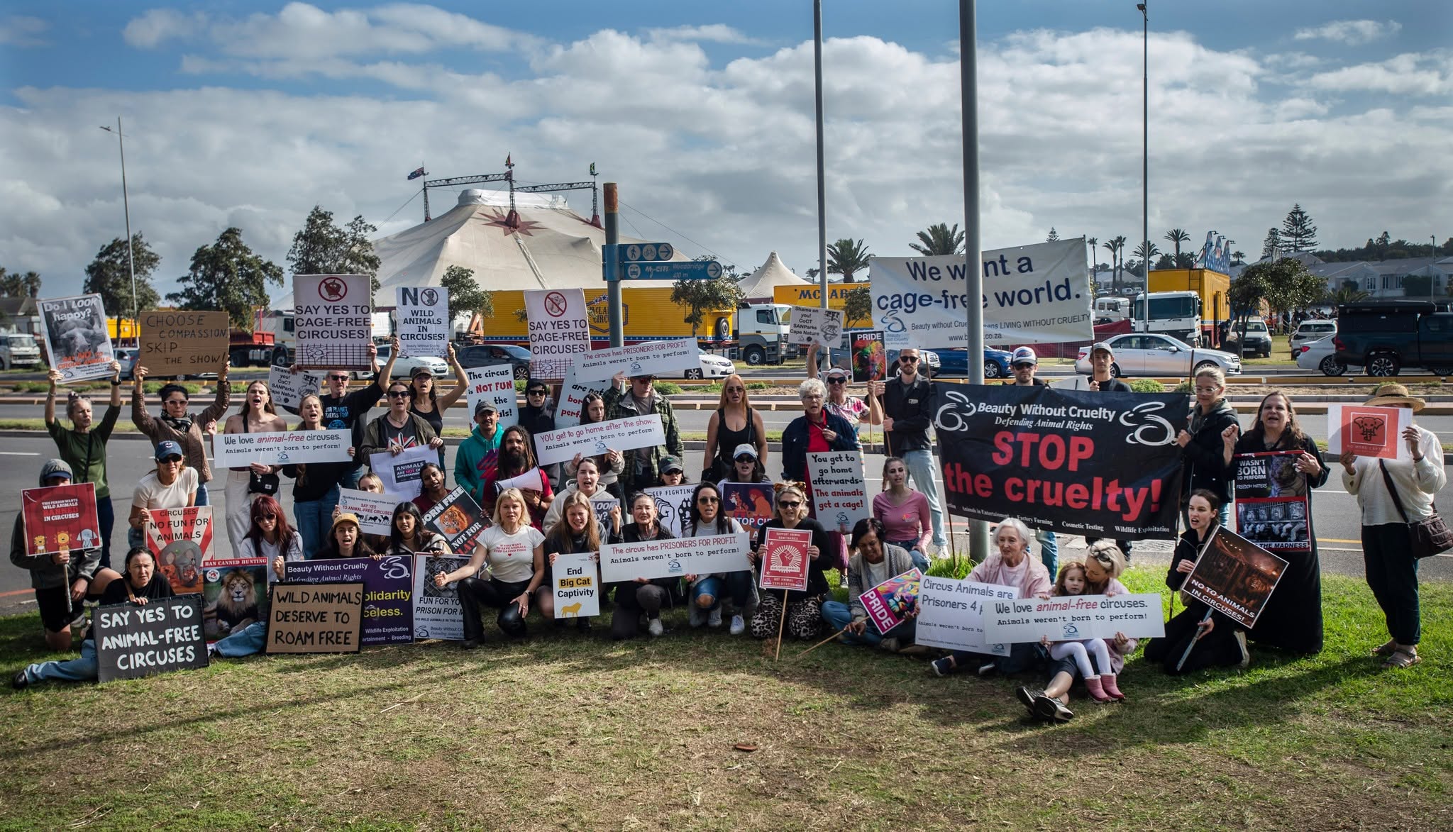 A large group of Beauty Without Cruelty campaigners holding placards calling for a cage-free world